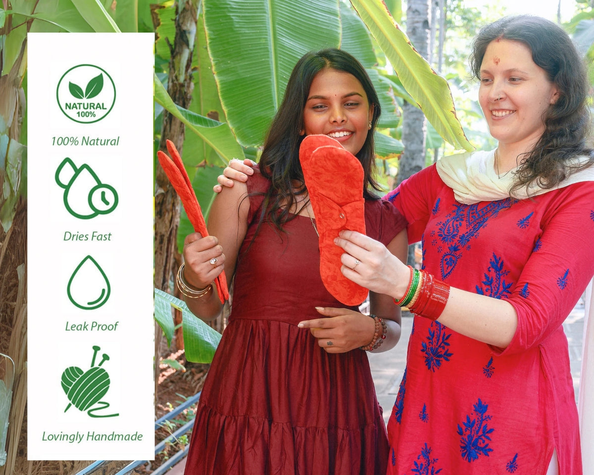Two women holding saukhyam reusable pads with text of "100% natural" "dries fast" "leak proof" "lovingly handmade"