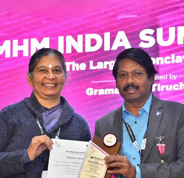 Woman and man holding an award and certificate