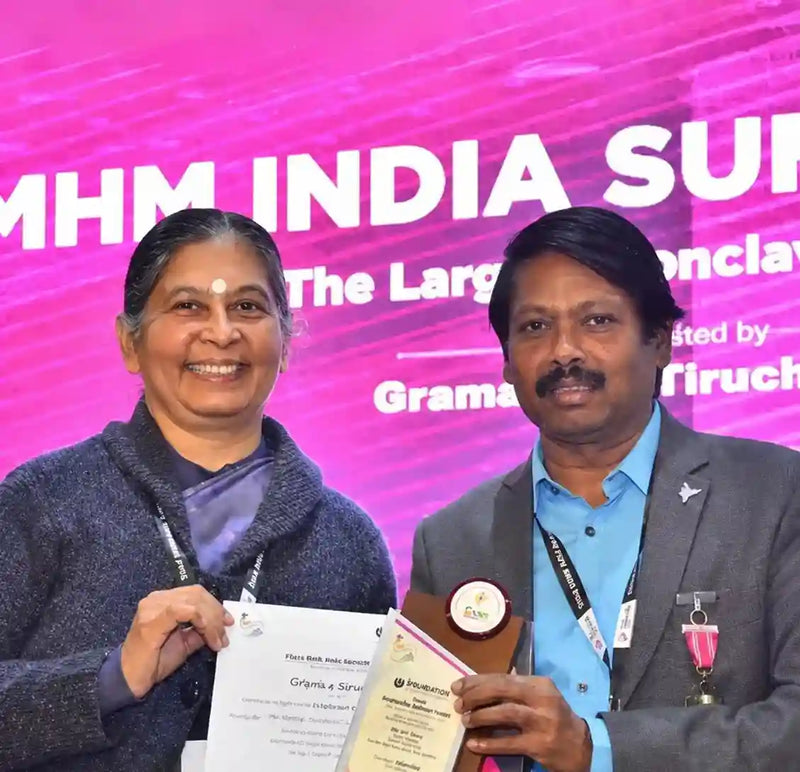 Woman and man holding an award and certificate
