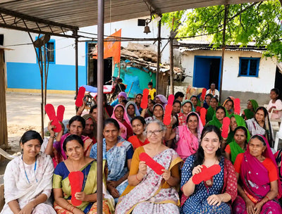 Women proudly holding reusable menstrual pads together